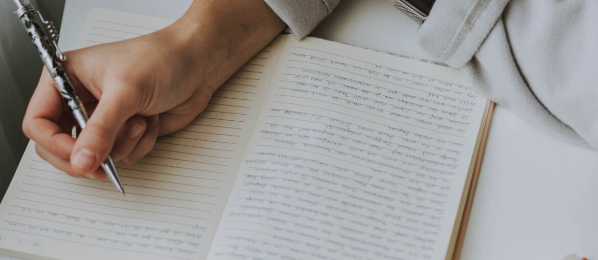 a person writing something in a notebook