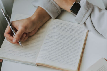 a person writing something in a notebook