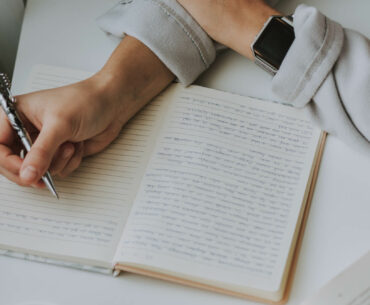 a person writing something in a notebook