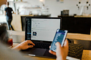 How to use Slack effectively in a remote team a person working remotely with his laptop open and the Slack app is visible on the screen
