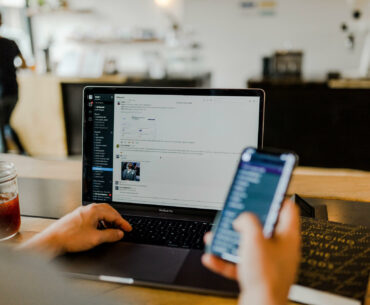 How to use Slack effectively in a remote team a person working remotely with his laptop open and the Slack app is visible on the screen